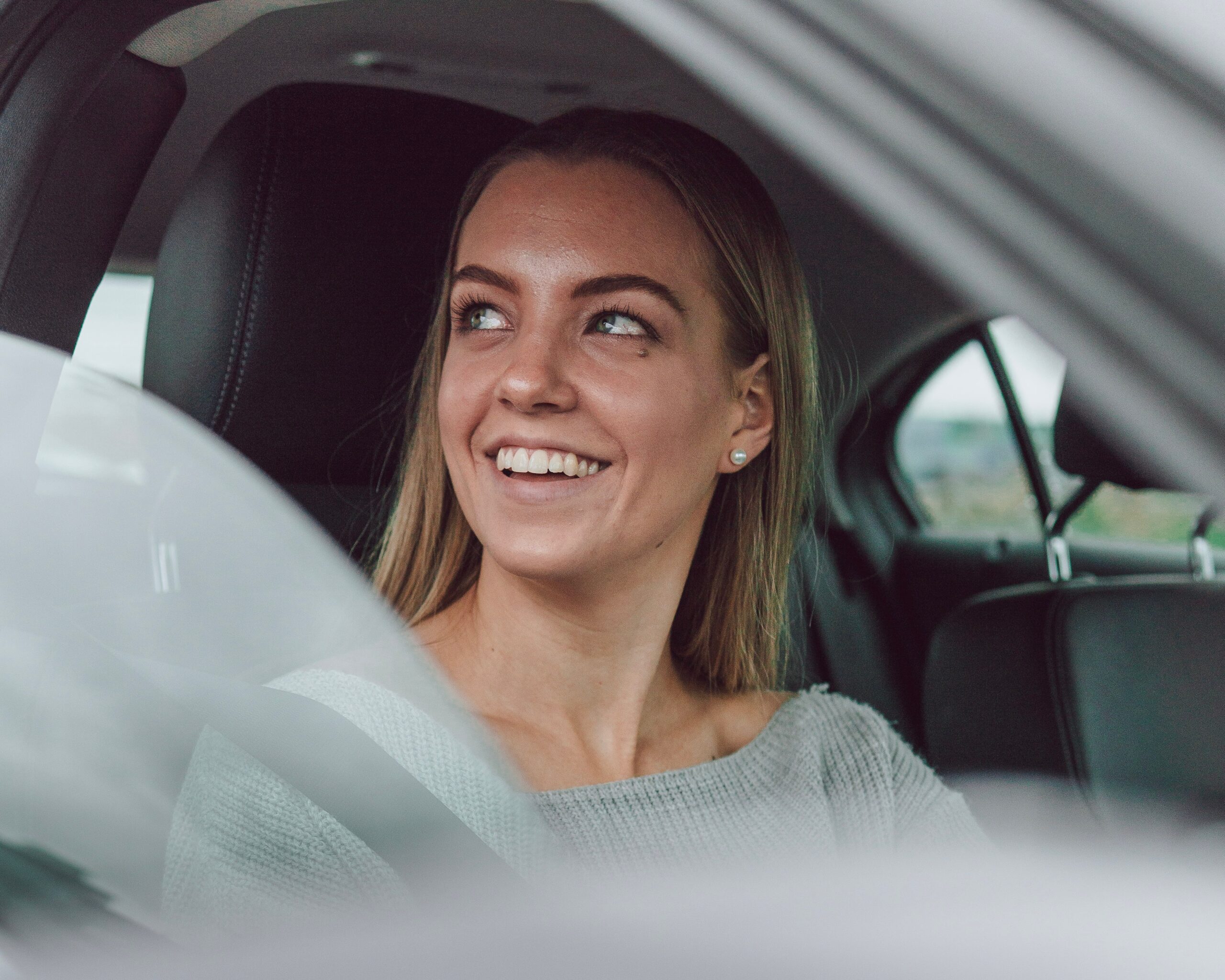 Woman in a car smiling